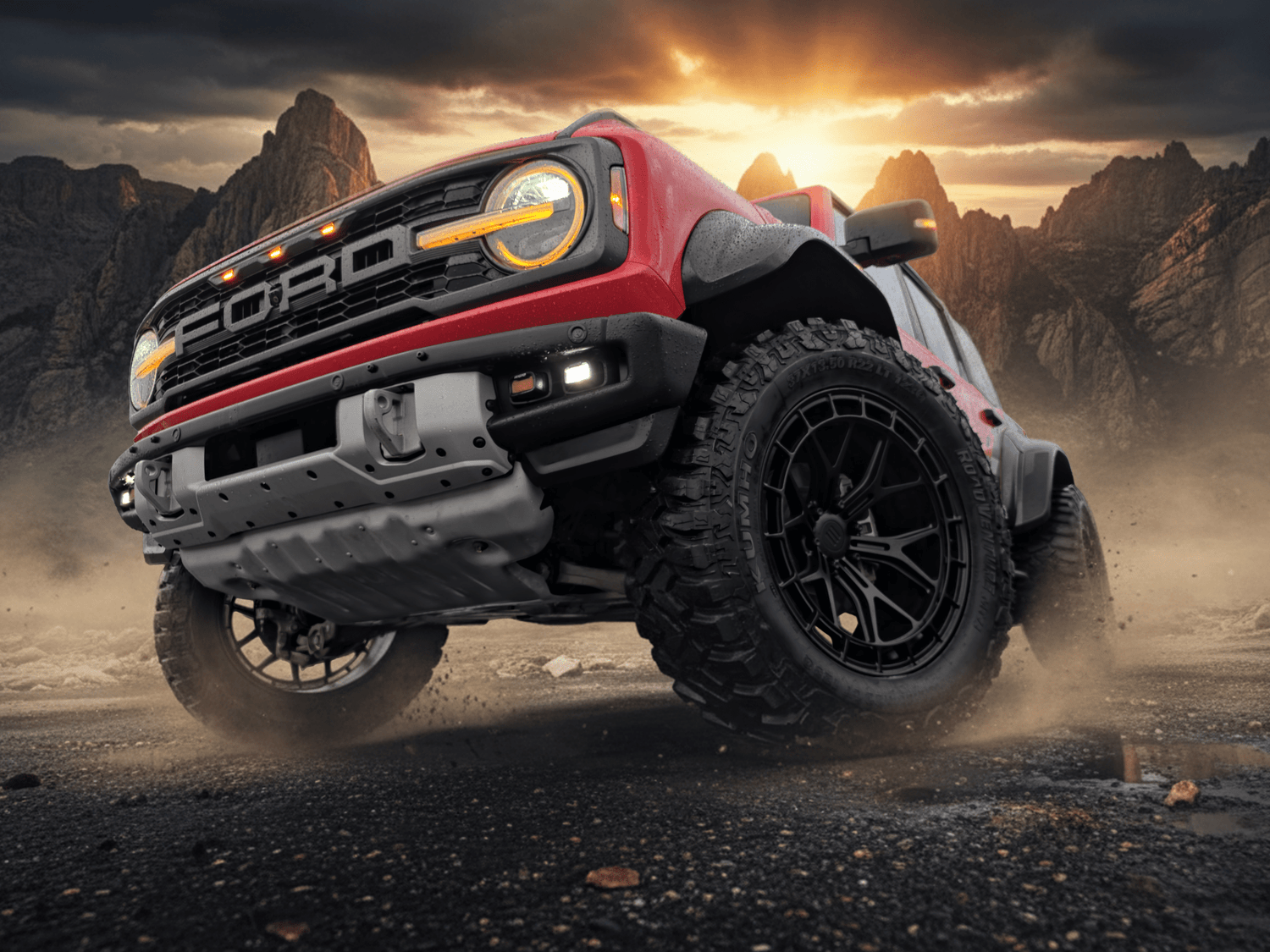 Ford truck driving on a dirt road with a dramatic sky and mountains in the background